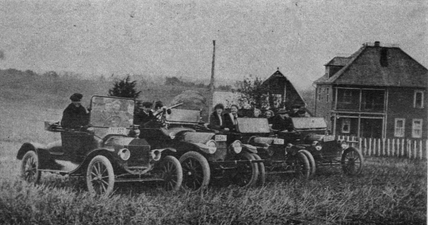 group of people in cars in the early 1900s